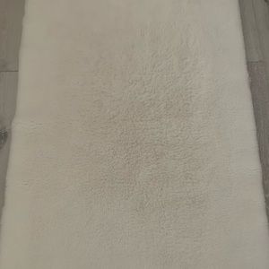 Small to medium white bedroom rug